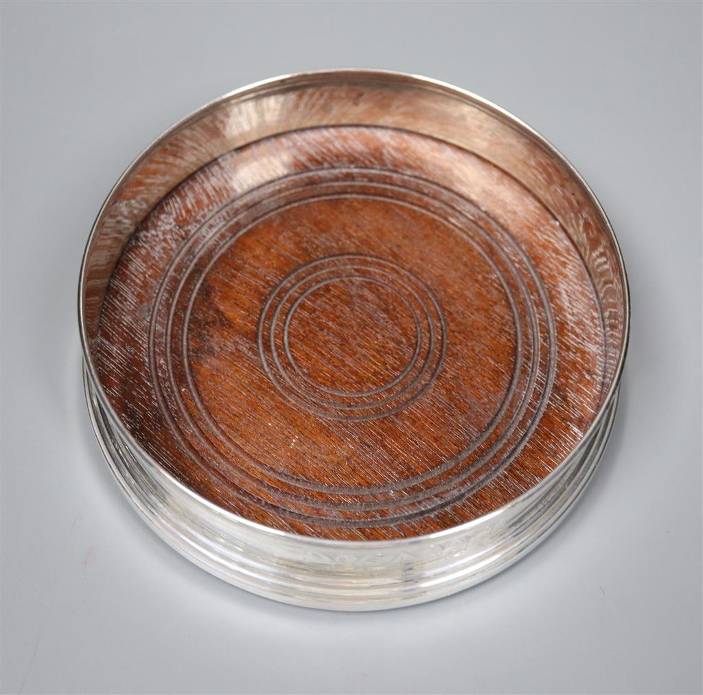 A circular silver wine coaster with engraved decoration, Birmingham 1980, base 12.6cm.